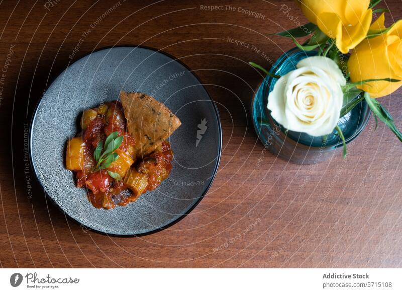 Gourmet grilled vegetable stew with sourdough cracker gourmet yellow pepper onion plate sophisticated food cuisine elegant dining hearty healthy tomato