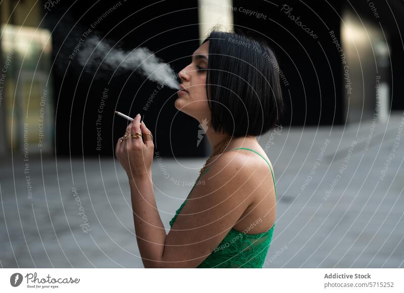 Urban chic woman smoking in Madrid's modern district cigarette smoke urban style young madrid spain contemporary 4 towers city fashion elegance stylish culture