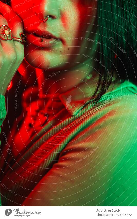 Close-up under neon: piercings and green fashion person close-up portrait red light face youth style vibrant color mood mysterious night urban trendy modern