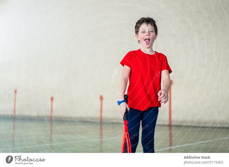Boy with tennis racket enjoying sport weekend boy child gym activity playful kid energy happy fun sporty leisure casual indoor healthy lifestyle exercise red