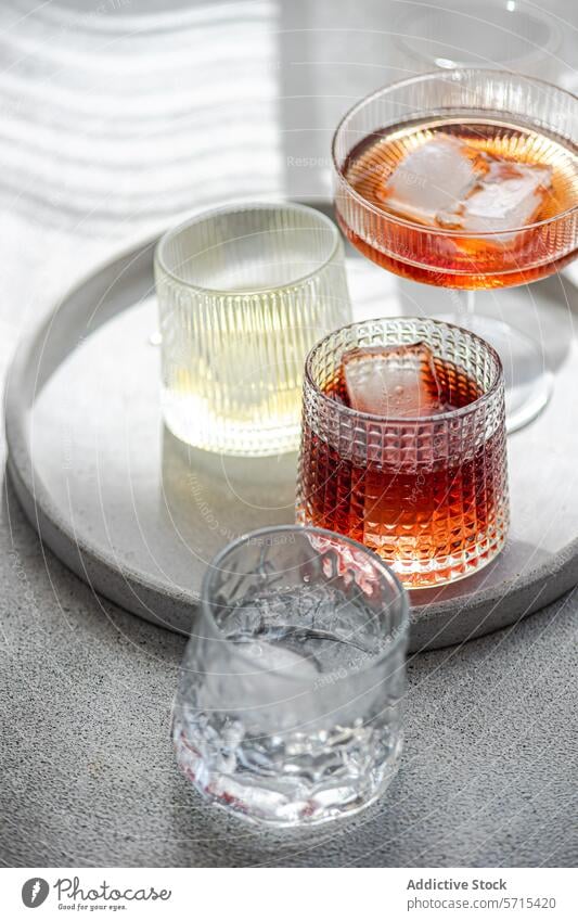 An assortment of alcoholic beverages on a round tray, each glass uniquely showcases a different drink assorted presentation elegant cognac cinnamon limoncello