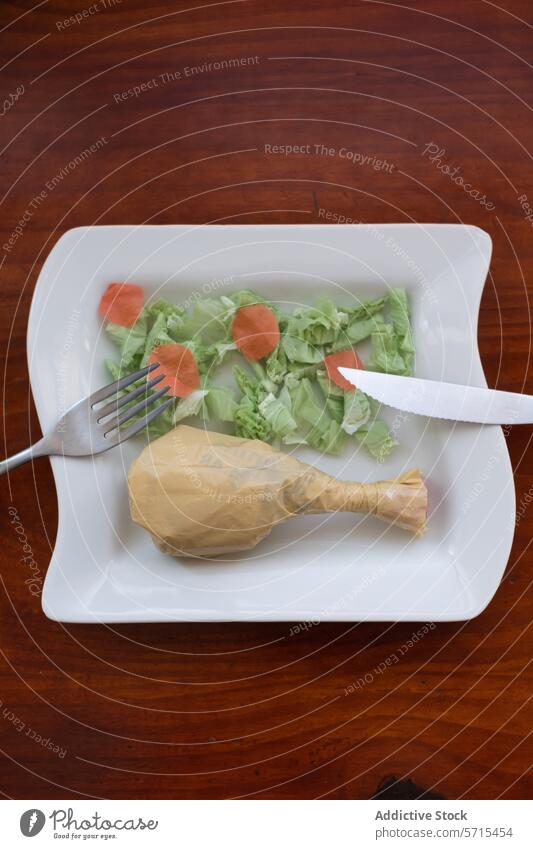 Plastic bag meal imitation on elegant dining plate plastic food environment pollution waste ceramic sophisticated salad carrot consumption issue representation