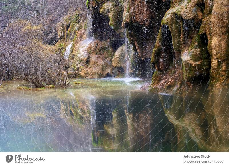 Crystal-clear waters flow from moss-covered rocks into a tranquil pool, reflecting the serene forest surroundings reflection Cuervo Cuenca river source natural