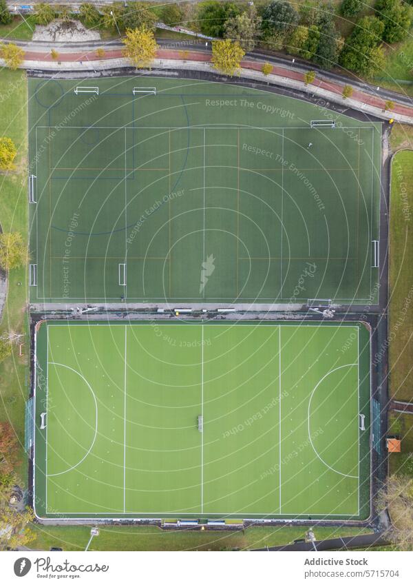 Aerial View of Empty Sports Fields aerial view sports field drone empty markings green grass soccer football pitch overhead outdoor rectangle boundary play game