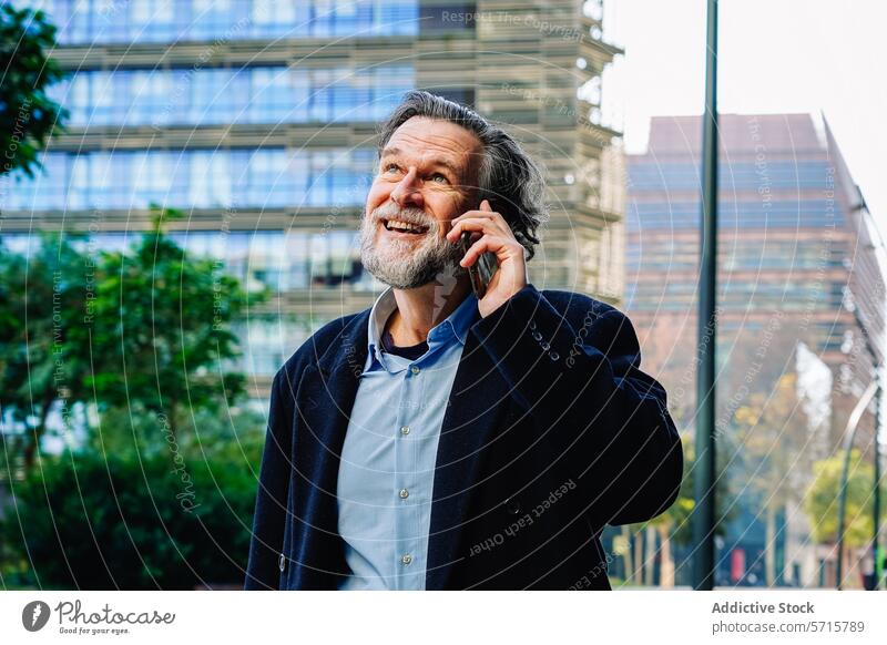 Smiling senior man talking on phone in urban setting conversation smiling businessman mobile technology city building mature professional communication outdoors