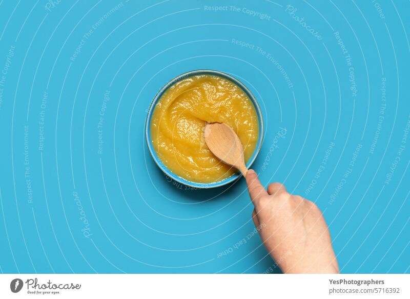 Homemade apple sauce top view on a blue background above autumn bowl bright color compote copy space cuisine cut out delicious design dessert diet dish flat lay