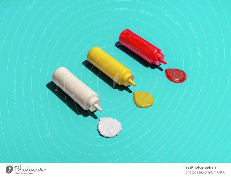 Sauce bottles above view, isolated on a blue background blank bright catsup clean color condiment copy space cream cuisine cut out delicious design drip eating