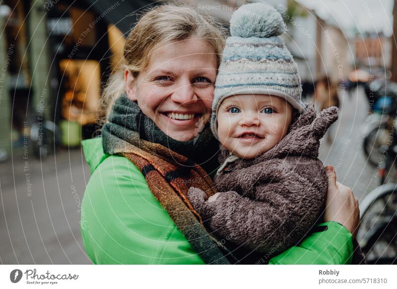 Mother with baby smiling into the camera Baby Child mama Toddler Woman youthful Blonde portrait Smiling Family Cute Infancy Parents Happiness