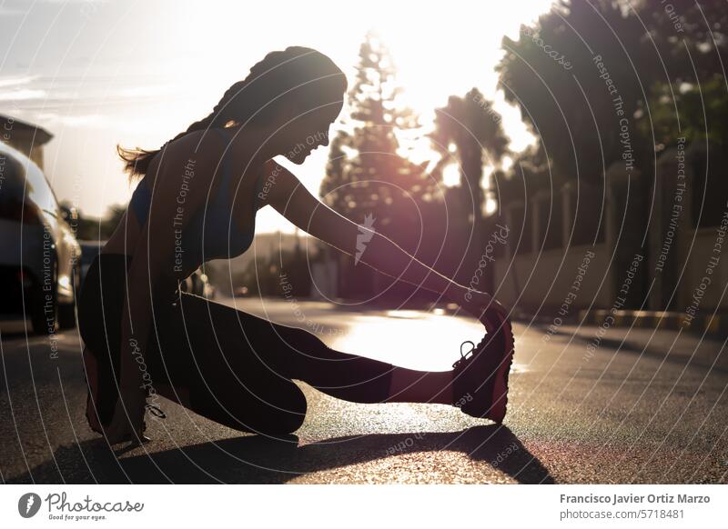 Woman in sportswear doing stretching in the street. Exercise concept woman fitness training lifestyle exercise female athlete young healthy exercising girl