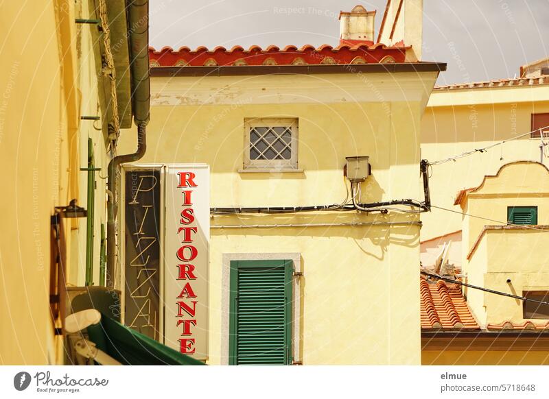 Houses in typical Italian style with RISTORANTE and PIZZA signs Italy Elba Restaurant Pizza ristorante Pizza sale Italian flair traditionally Lunch Island