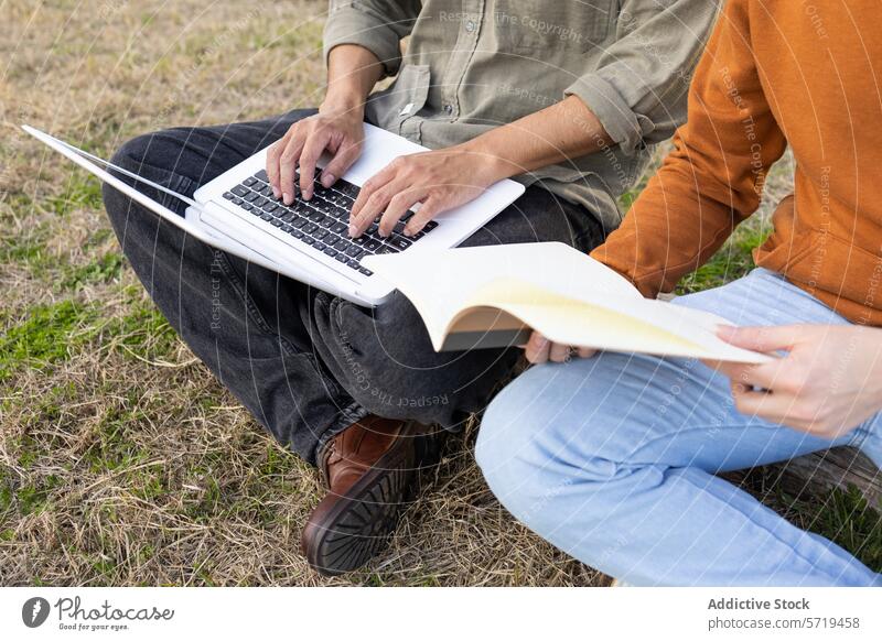 Anonymous college students studying with laptop on picnic homework book grass education outdoor man woman multitasking technology learning university paper