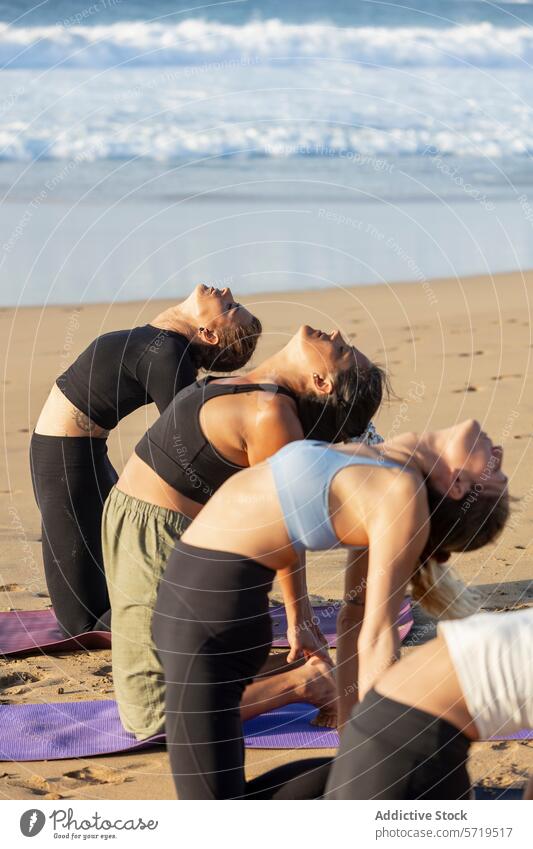 Serene beach yoga with practitioners in backbends wellness harmony nature class session pose posture exercise fitness health peace serenity outdoor sand water
