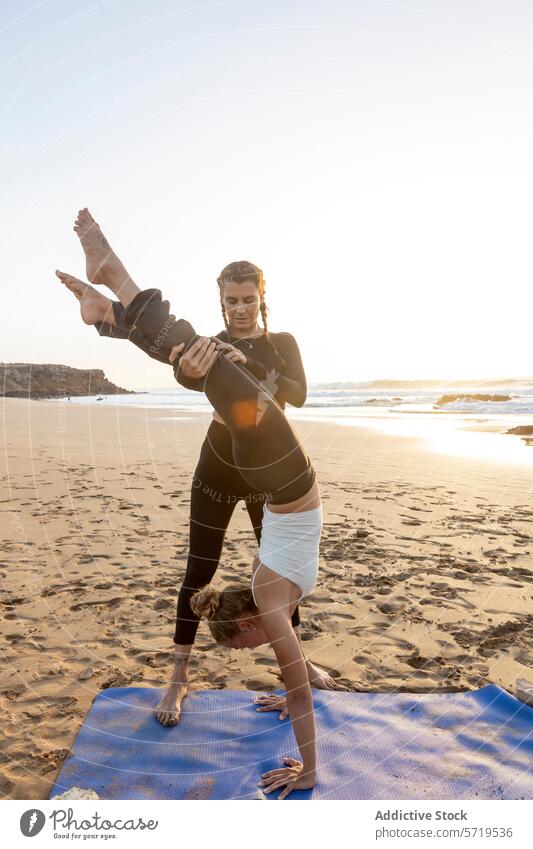 Sunset beach yoga session with partner acrobatics sunset balance strength pose mat sand ocean outdoor exercise fitness flexibility health well-being