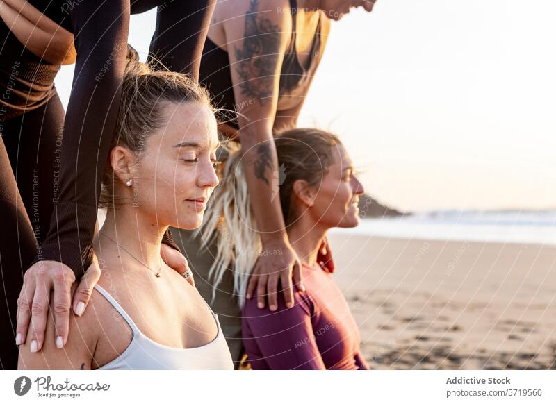 Sunset Beach Yoga Class in a Serene Setting yoga beach sunset class group instructor assistance serene backdrop sand practice pose exercise wellness health