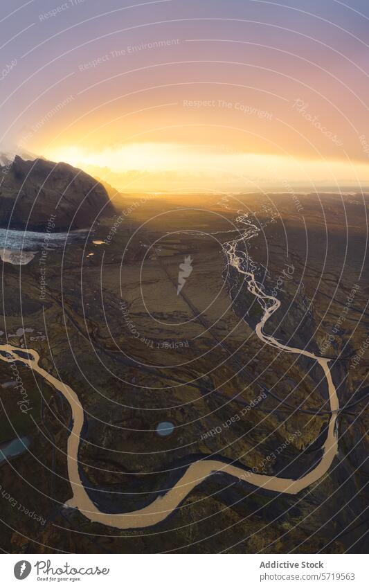 Majestic rivers meandering through a vast landscape at sunset aerial view terrain warm glow setting snaking winding diverse aerial photography nature outdoor