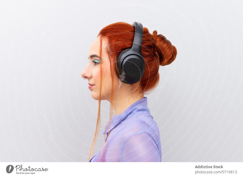 Red-haired Female Executive with Stylish Headphones woman red hair headphones music business executive young adult caucasian professional makeup blue eyeshadow