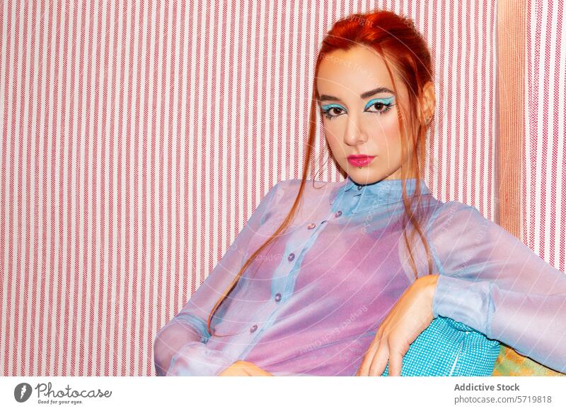 Confident young businesswoman against striped background caucasian confident professional fashion stylish pastel blouse intense gaze red vibrant bold assertive