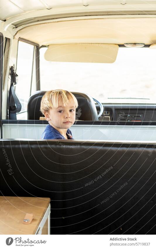 Young boy relishing a trip in an old-fashioned van vintage travel adventure family seat portrait candid joy simple road trip childhood enjoyment leisure