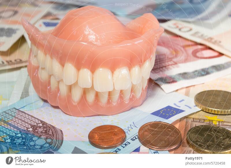 Artificial teeth are on many banknotes. Set of teeth Teeth Money Healthy Expensive additional payment Health care Dentistry Close-up Dental Own contribution
