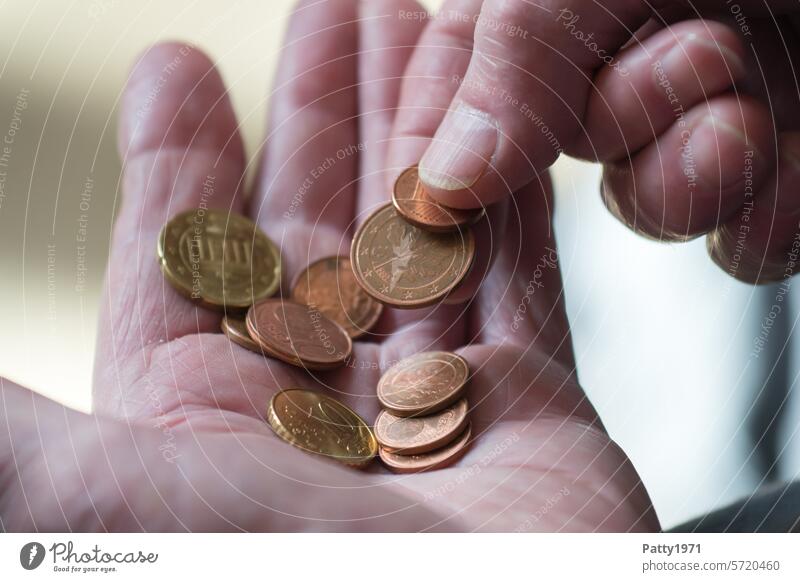 Pensioner counts change in the palm of his hand. Money Hand Pensioners Save geriatric poverty finance Numbers Coins detail Close-up rotten senior citizens