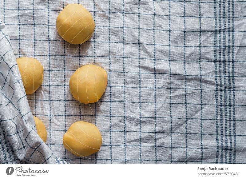 Yeast dough balls on a tea towel. Top view. Raw biscuits Self-made let go Bread Donut Pizza Preparation Bakery Flour Baking Cooking Striped plan Eating