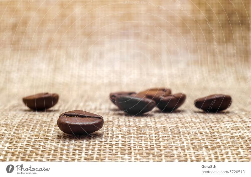 several coffee beans on a matting macro aroma backdrop background beige black blur blurry breakfast brown cafe caffeine close close up coffee background
