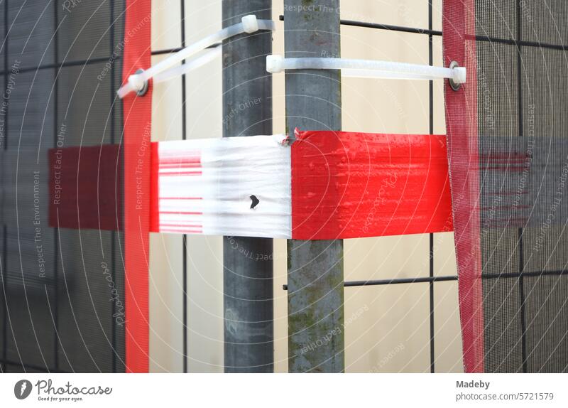 Construction fence with plastic banderole in red and white at the exhibition halls at shaft XII of the Zollverein colliery in Essen in the Ruhr area in North Rhine-Westphalia in Germany