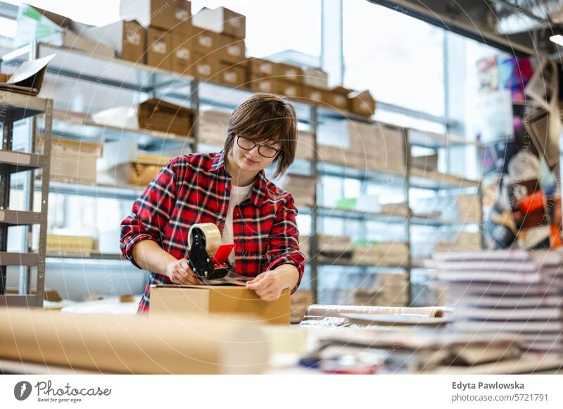 Female Worker Taping Cardboard Box business employee factory female industrial industry job logistics manufacture manufacturing occupation people product