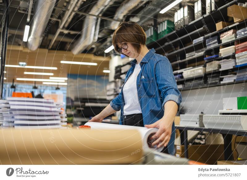 Woman working in a printing factory business employee female industrial industry job logistics manufacture manufacturing occupation people product production