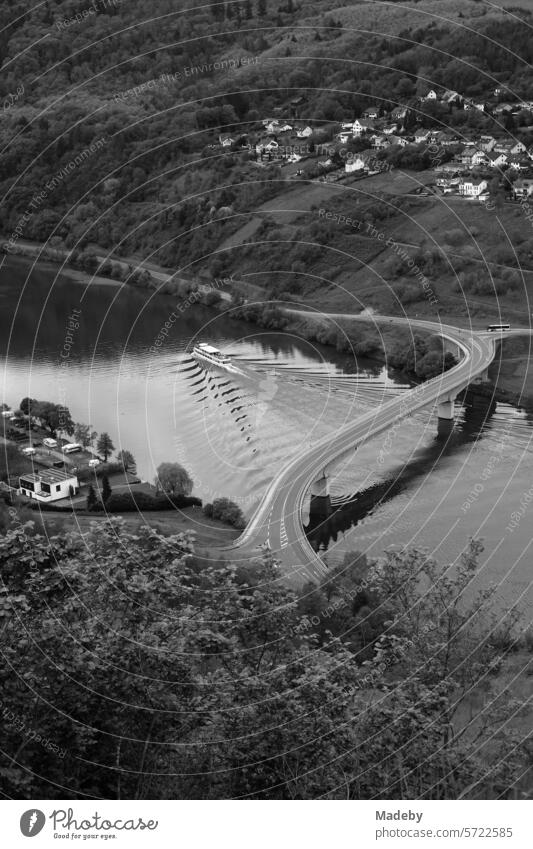Magnificent panorama on the Moselle with a magnificent landscape and modern bridge between mountain and valley in sunshine in Traben-Trarbach in the district of Bernkastel-Wittlich in Rhineland-Palatinate in Germany in neo-realistic black and white