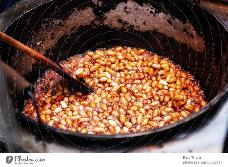 Caramelising Peanuts- Street Food caramelized warm Delicious yummy Brown Spoon Pot wooden sweet tasty baked food homemade fresh gourmet sugar delicious