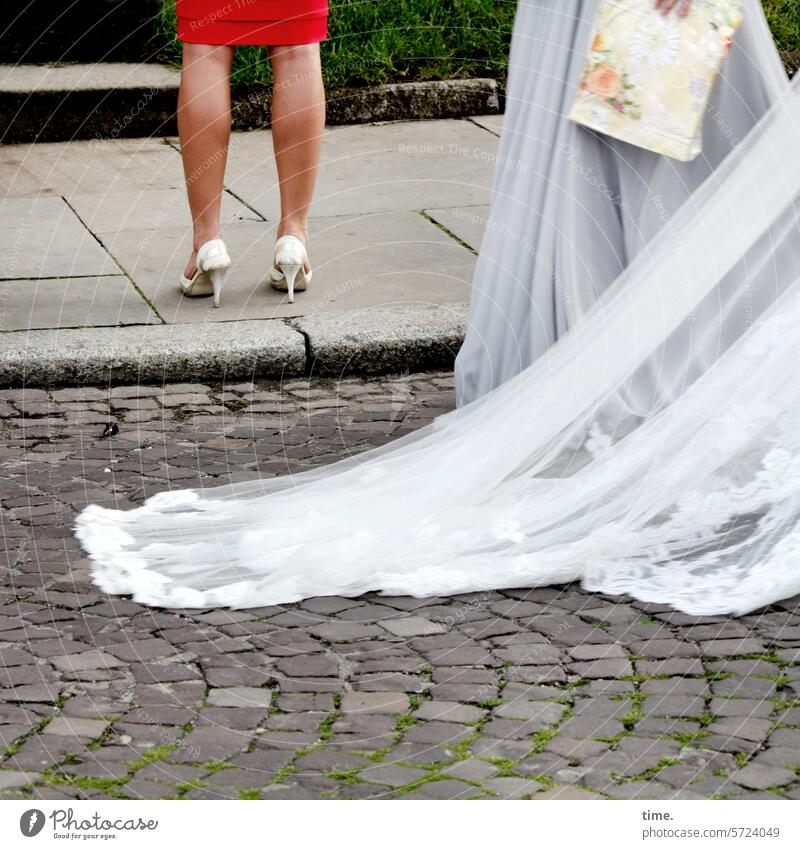 Potential for conflict Wedding Wedding dress Vail Bag Legs Dress Street curb Cobblestones turned away women Festive clothing Cloth averted urban celebration
