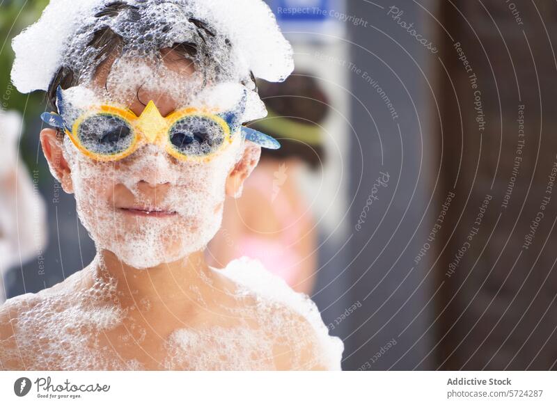 Joyful boy covered in foam at party child fun playful sunglasses joy happiness celebration white leisure activity event outdoor daytime summer festive