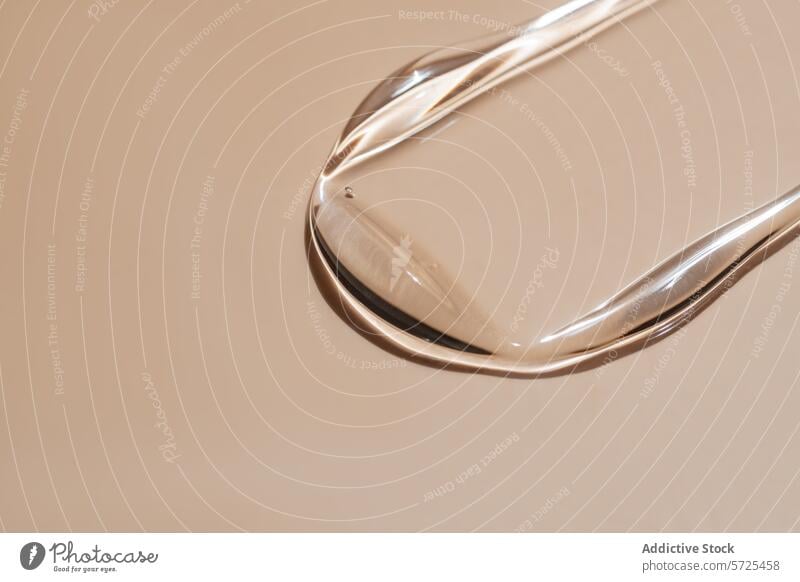 Close-up of liquid serum swatch on beige background beauty skincare cosmetic close-up product reflection surface droplet glossy translucent elegance hydration