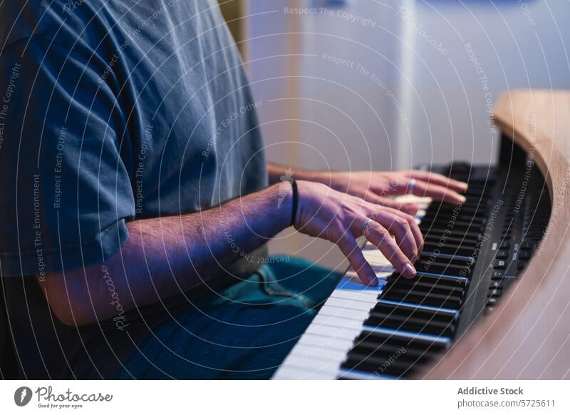 Cropped anonymous musician playing piano during studio recording session hands keys sound close-up expertise instrument digital performance artist fingers