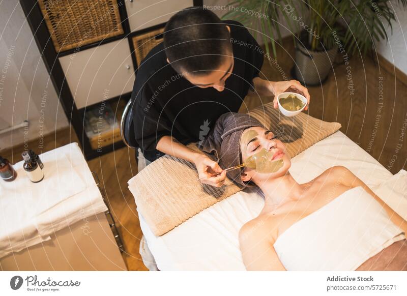Relaxing facial treatment at a peaceful spa setting mask woman esthetician skincare relaxation beauty pampering wellness health green apply lying bed service