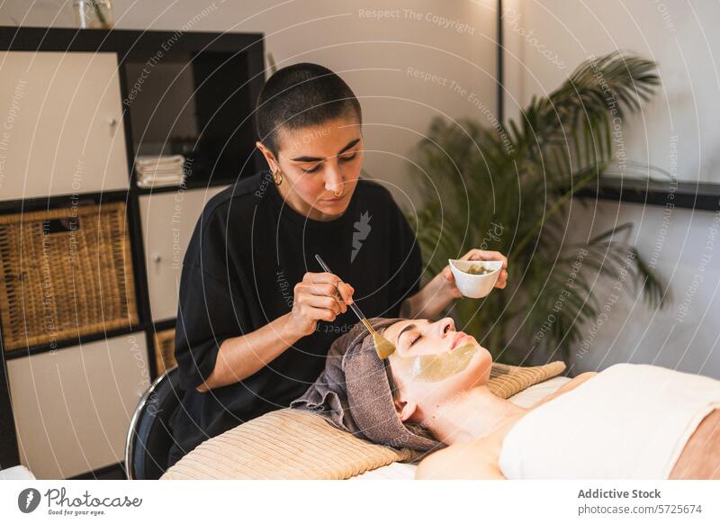 Beautician applying facial mask in a wellness spa beautician client skincare treatment woman relaxation beauty therapy aesthetician green gentle serene