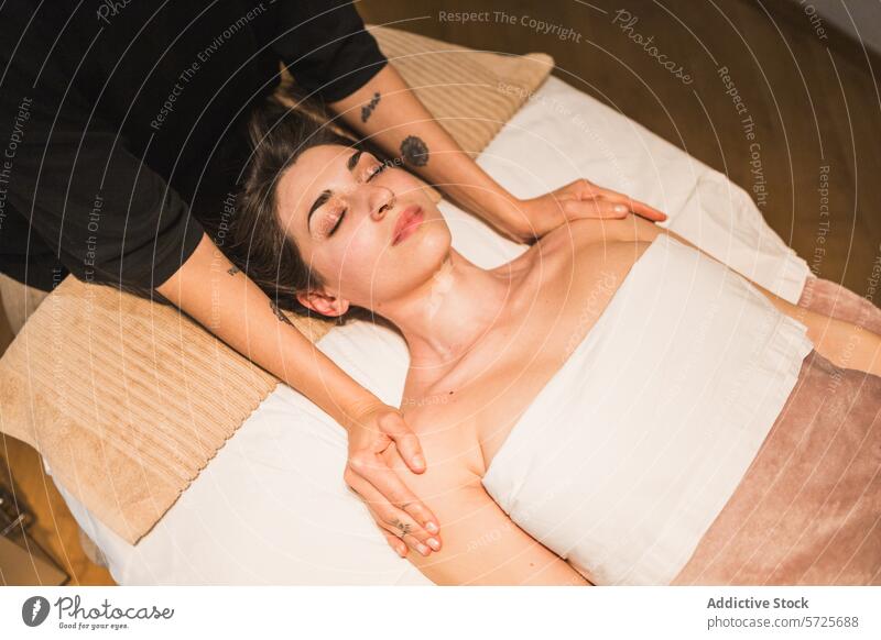 Serene woman receiving a relaxing shoulder massage spa relaxation serenity wellness tranquility therapy touch skincare health comfort luxury treatment therapist