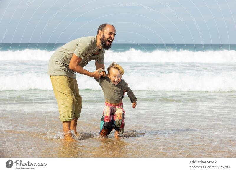 Joyful father and child playing in sea waves beach fun joy shallow water sand coast ocean family laughter bonding quality time happiness carefree toddler parent