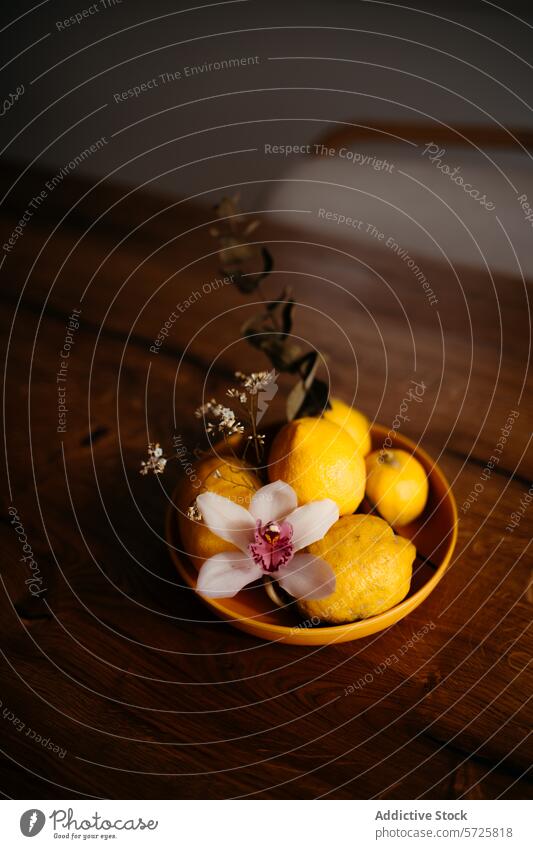 Elegant display of lemons and orchid in a bowl wooden surface arrangement ripe fruit ceramic delicate floral elegance still life tabletop natural decoration
