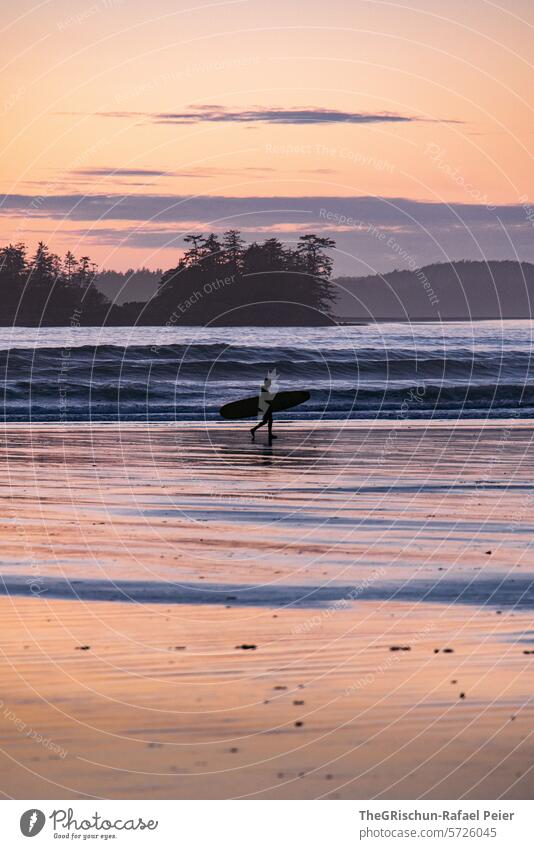 Surfers walking along the beach in the evening mood cox bay Vancouver Island Ocean White crest Waves Canada British Columbia North America Water coast Nature