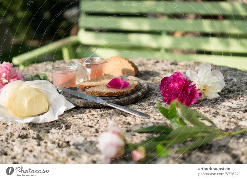 Breakfast in the garden with homemade rose petal jam, butter and bread on a stone table Garden Plant Green Nature Foliage plant Exterior shot naturally Park