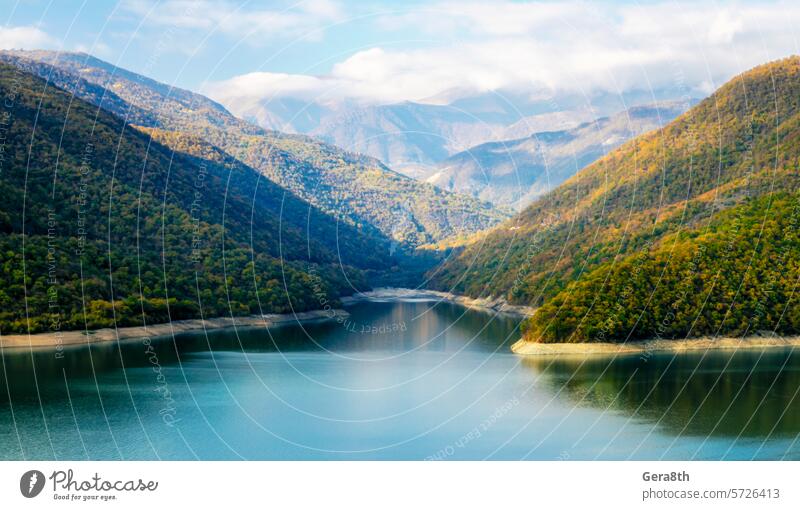 autumn landscape of mountains and lake in Georgia Caucasus background blue bright calm climate autumn clouds color day fog forest green haze hill holiday