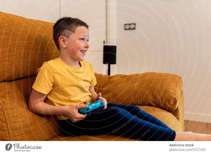 Smiling boy enjoying video games on a cozy sofa child controller playing gaming smiling fun leisure activity engagement enjoyment young home living room couch