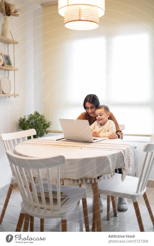A heartwarming moment as a smiling mother embraces her son while they both engage with content on a laptop at home family togetherness happiness work play joy