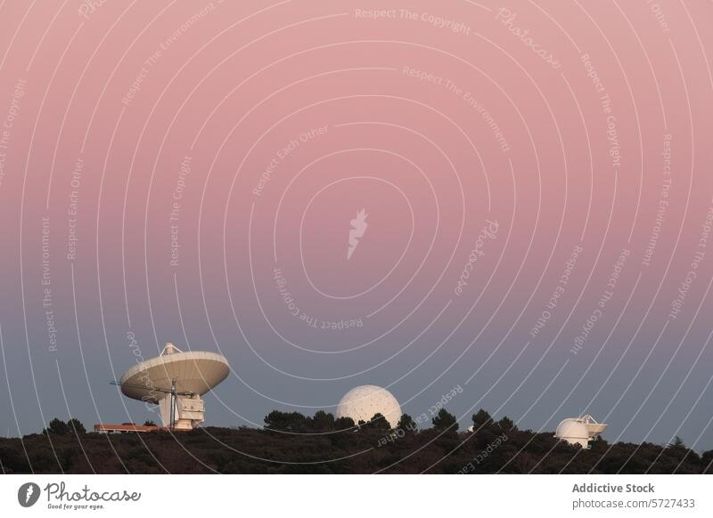 Satellite dishes and observatory under a pastel sunset sky satellite scientific station serene large antenna dusk research communication technology science