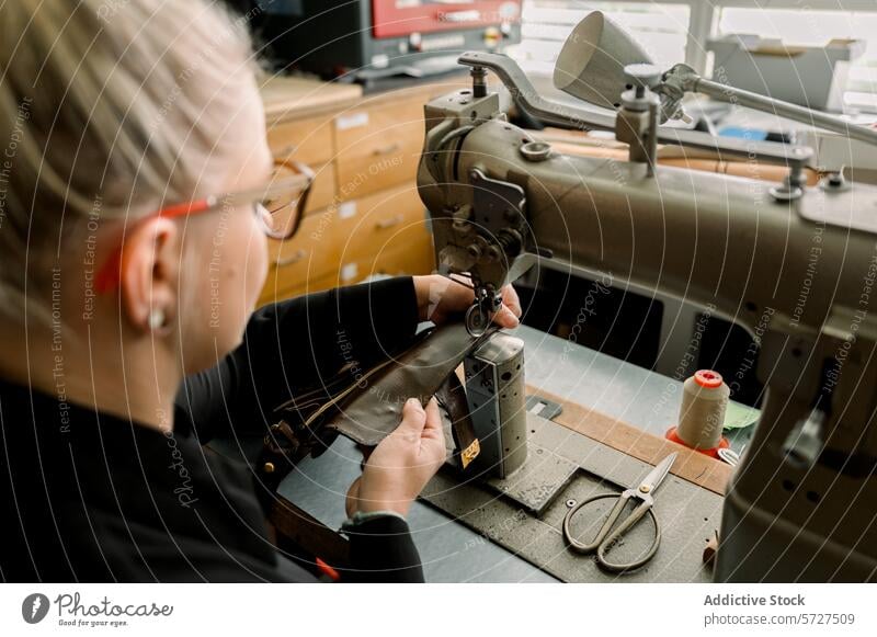 Artisan shoemaker at work in Austrian workshop artisan austria craftsmanship leather sewing machine stitching equipment handcraft tradition shoemaking skill