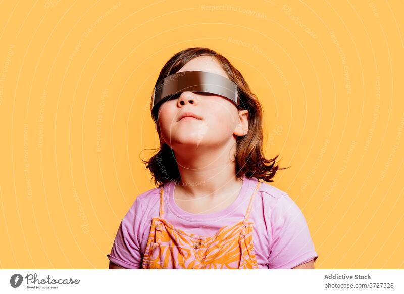 Child experiencing virtual reality with VR headset child girl vr technology future innovation entertainment gaming bright orange background isolated youth