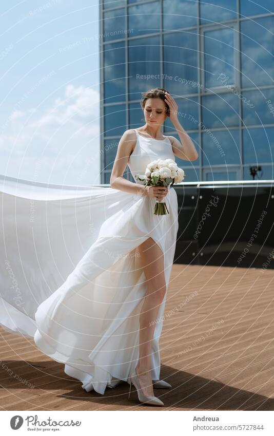 bride the roof of skyscraper blue bouquet city day dress first forever groom happiness joy meeting newlyweds smiles suit summer together top two walking wedding