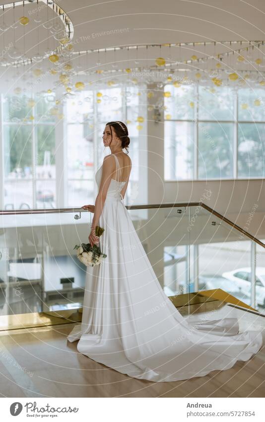 bride on the gold hotel stairs bouquet brown day dress first girl guy marry meeting newlyweds smile steps suit together towards two wedding white young